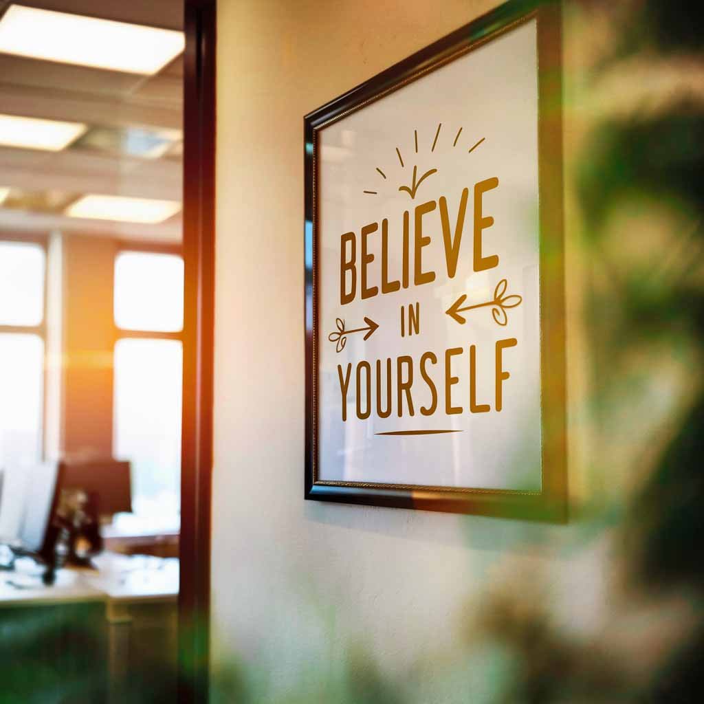 Motivational Wall Art: An office wall features a framed motivational art piece that reads "Believe in Yourself".